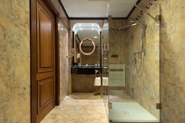 a bathroom with a glass shower and a sink