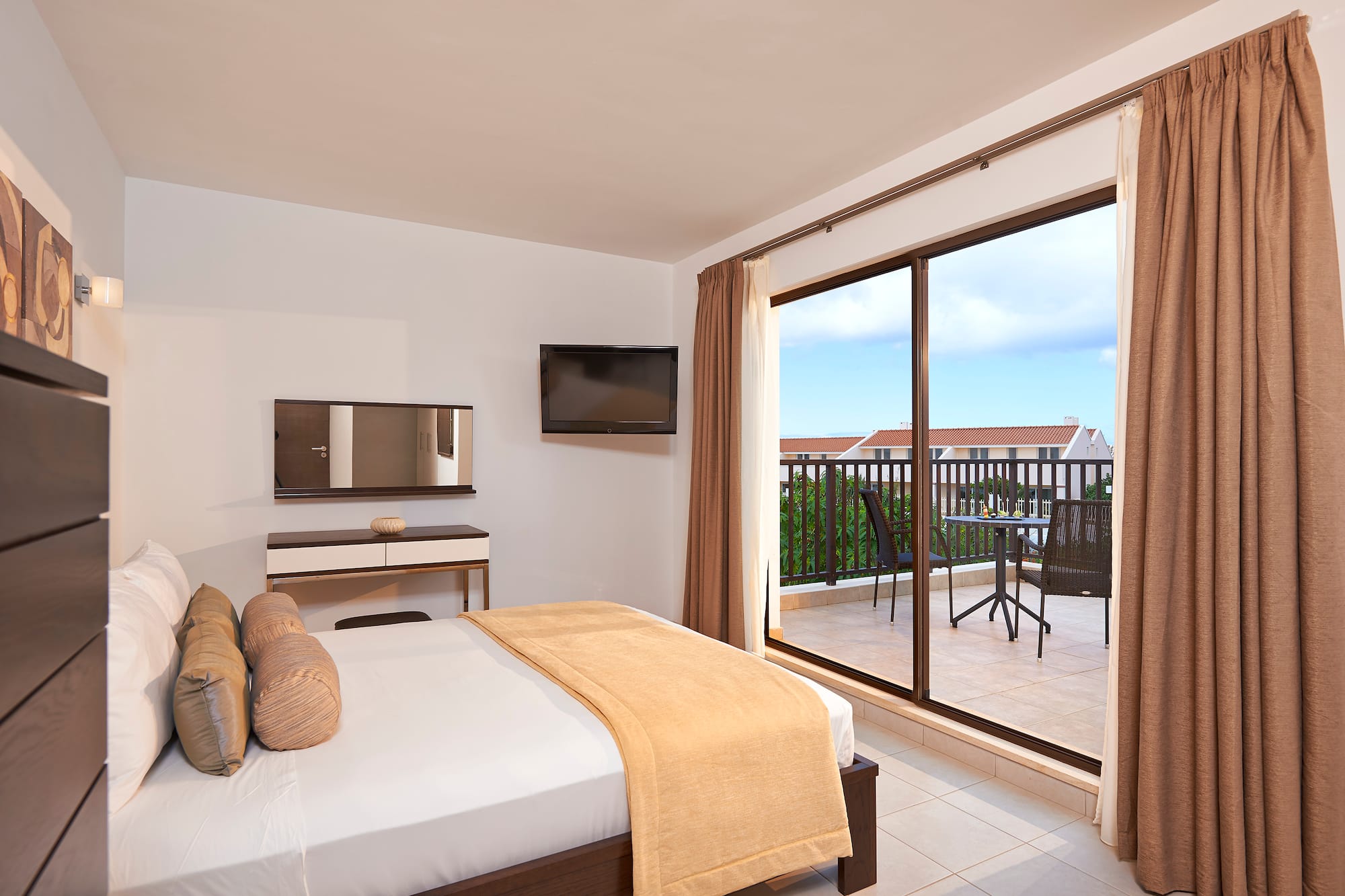 a bedroom with a glass door and a bed