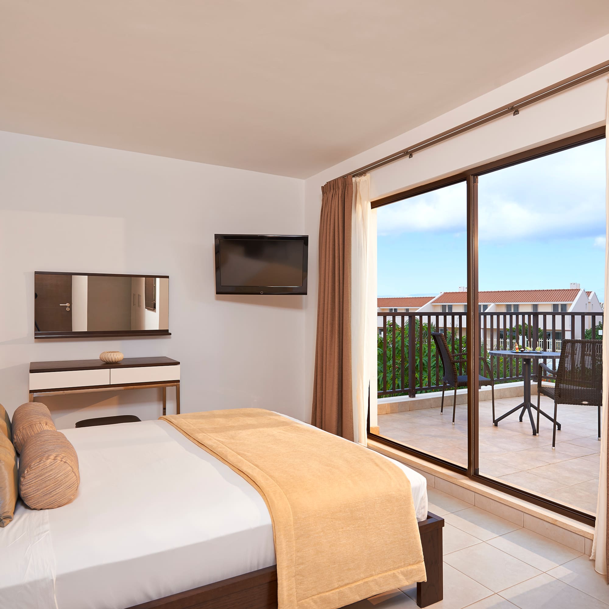 a bedroom with a glass door and a bed