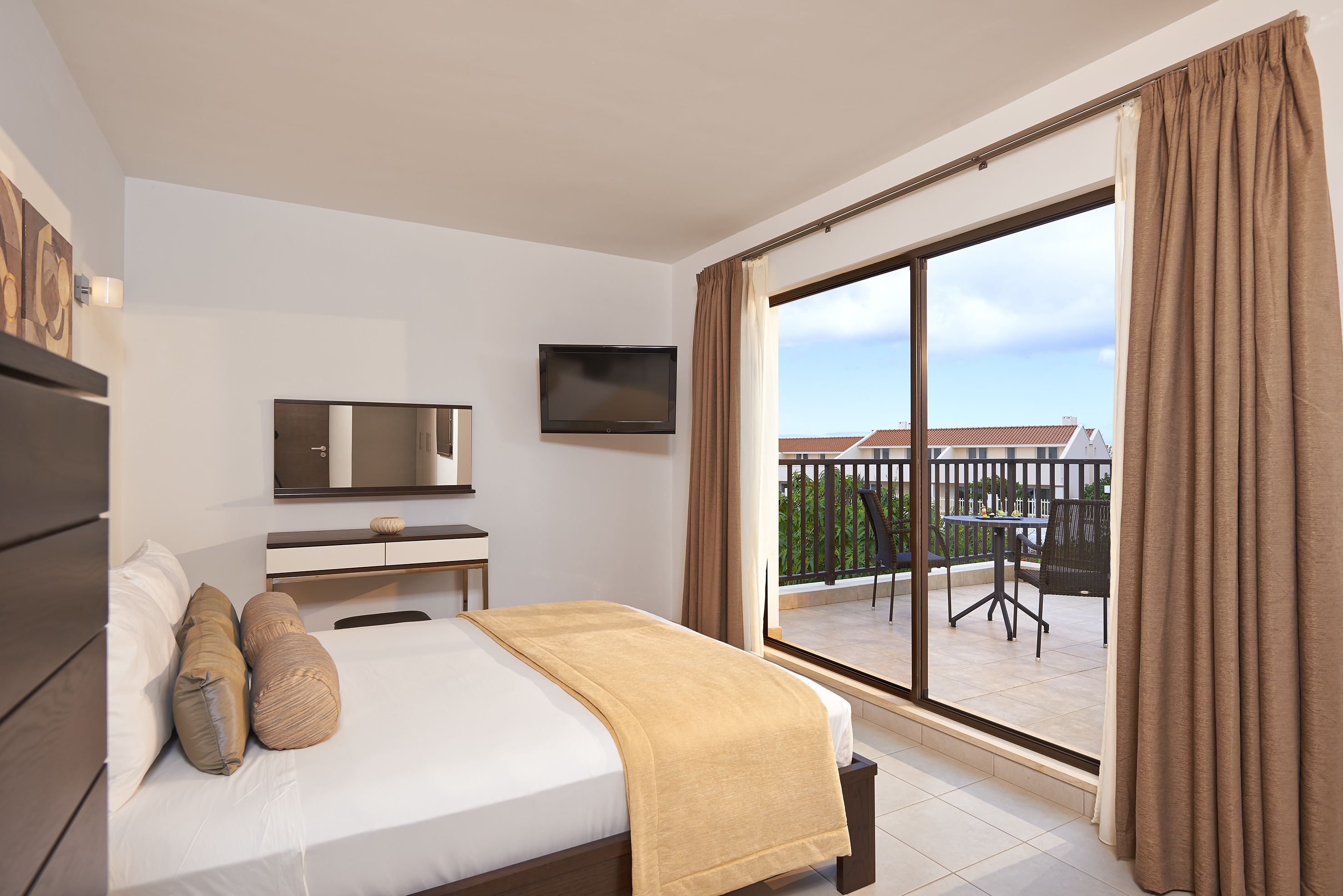a bedroom with a glass door and a bed