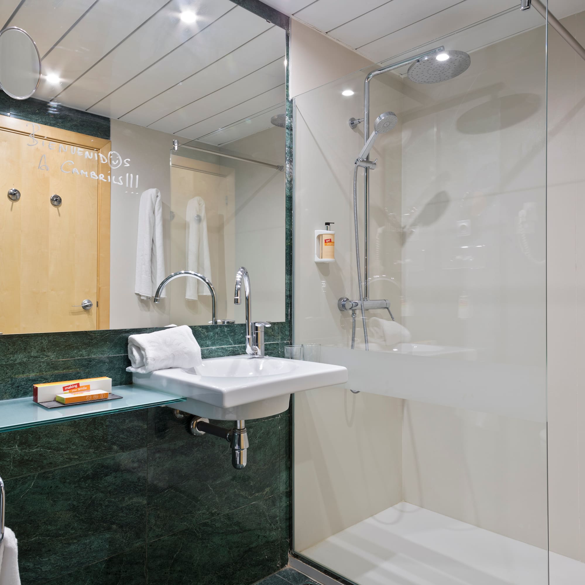 a bathroom with a glass shower and sink