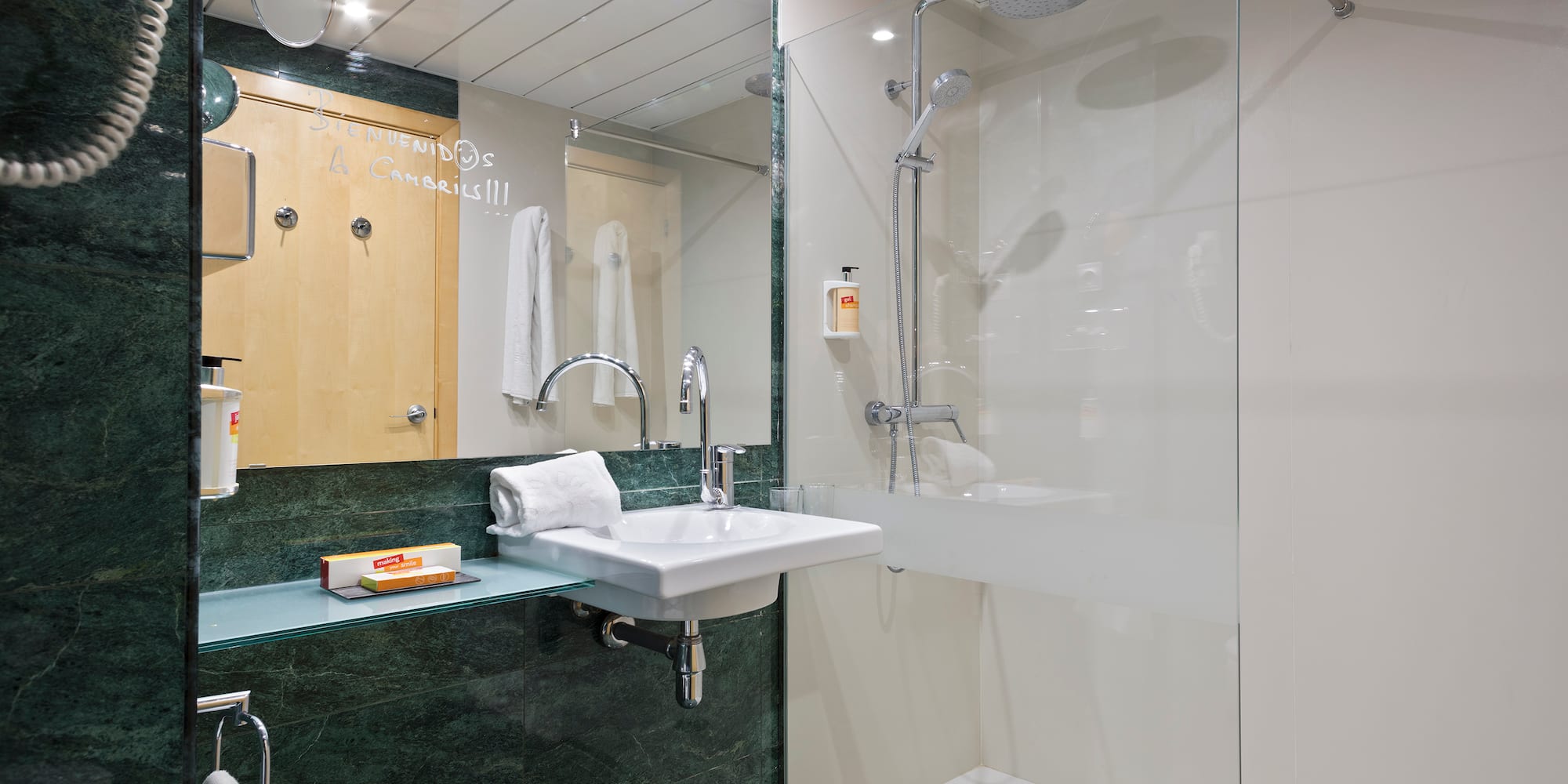 a bathroom with a glass shower and sink
