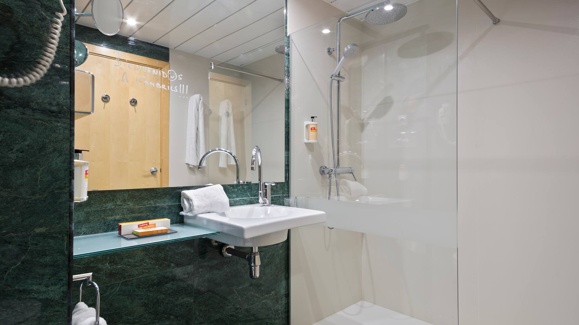 a bathroom with a glass shower and sink