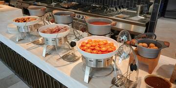 a buffet table with food in bowls