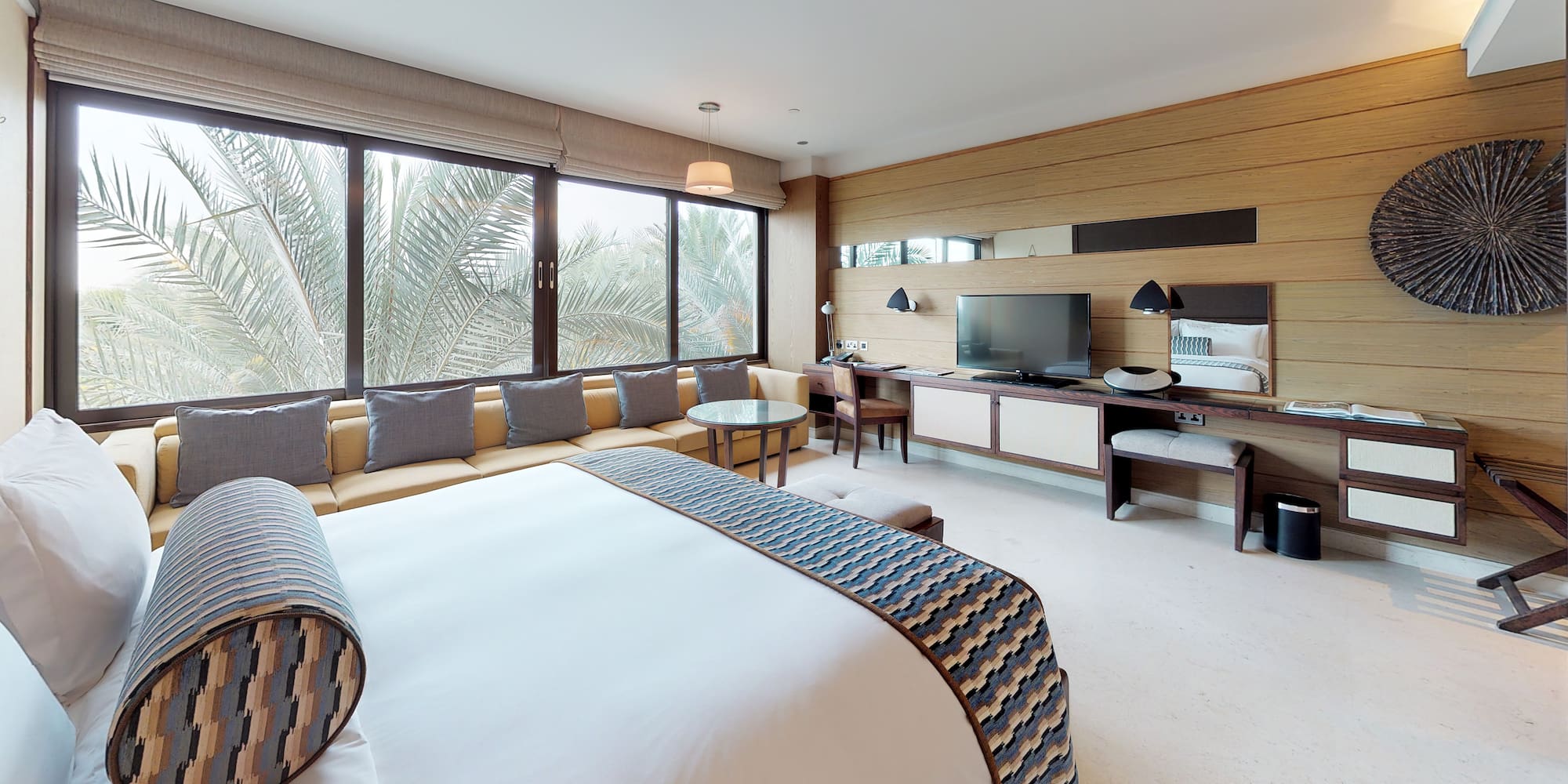 a room with a bed and a television