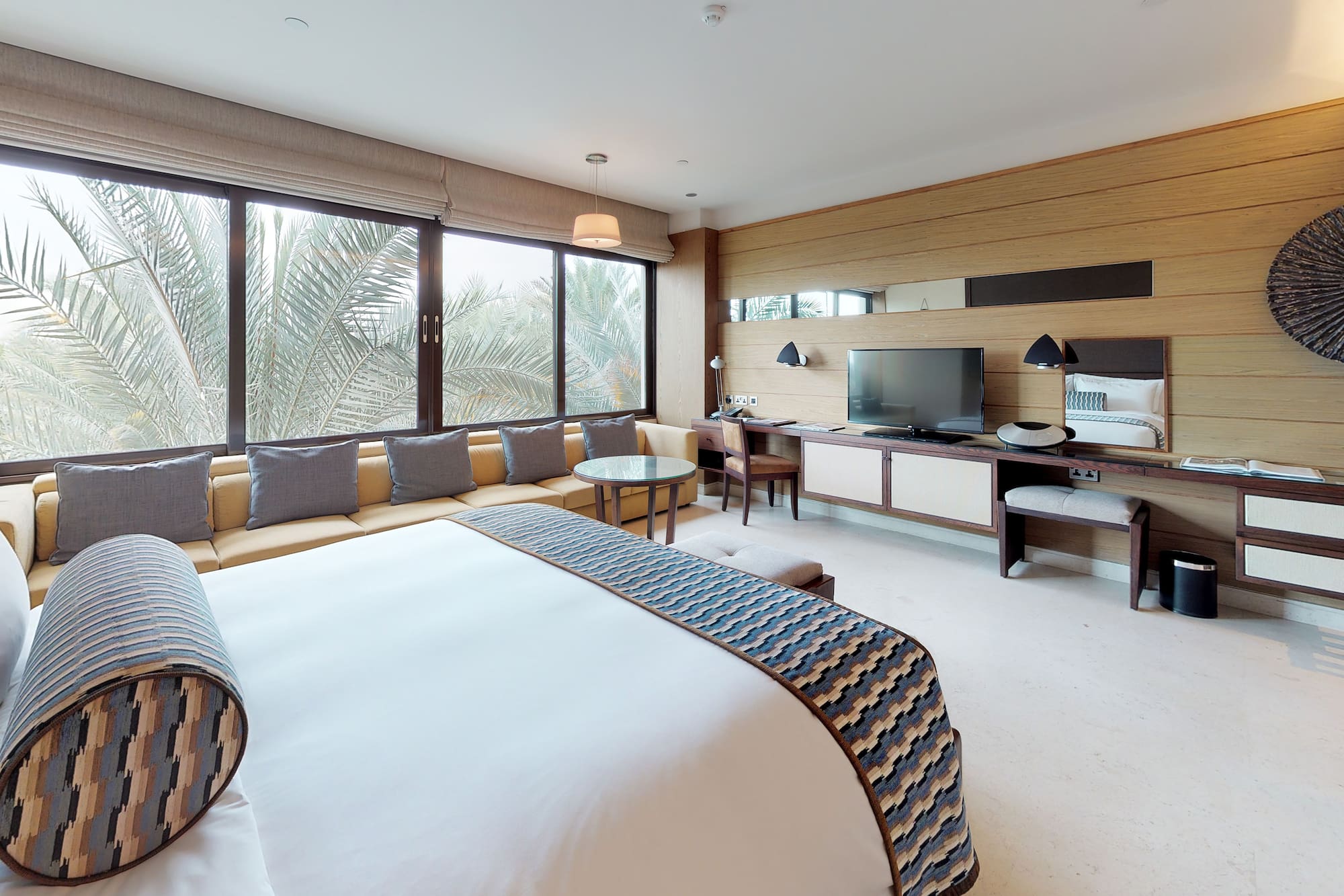 a room with a bed and a television