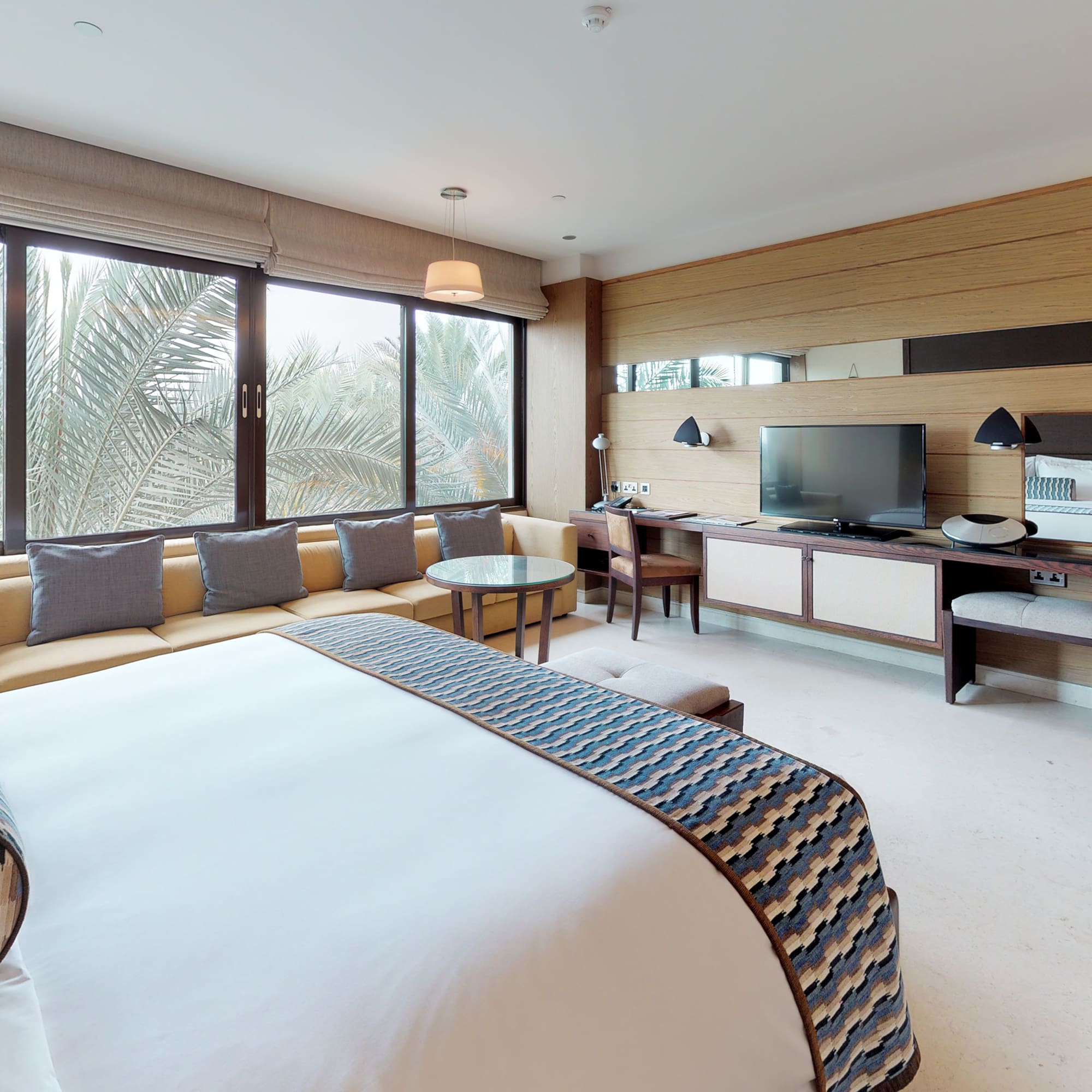 a room with a bed and a television