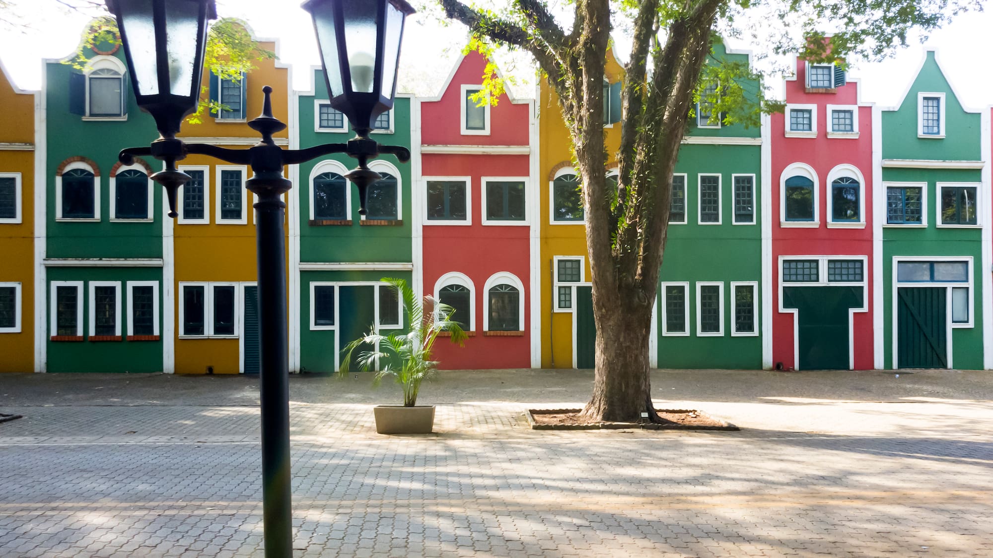 a street lamp in front of a row of colorful buildings