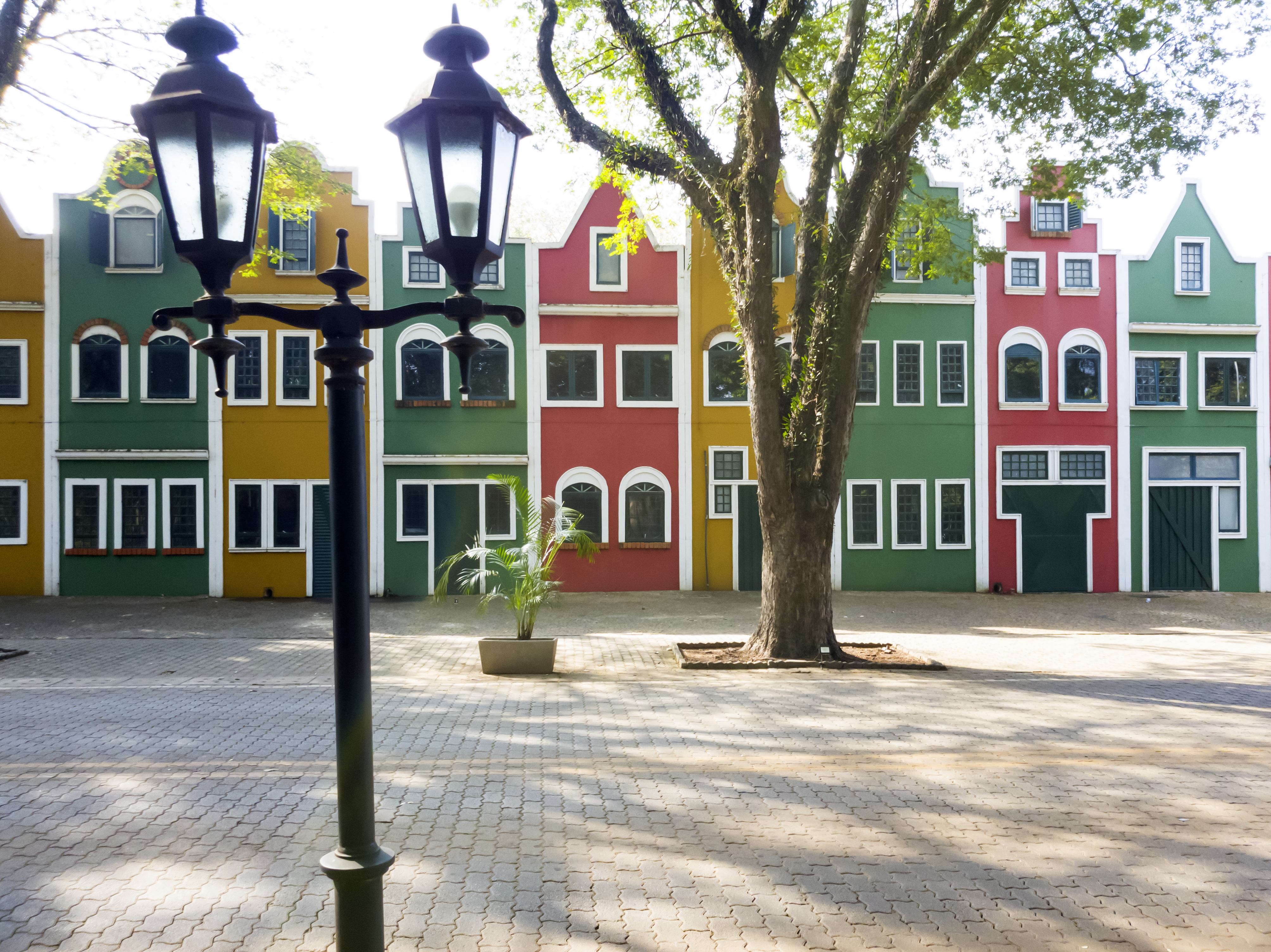 a street lamp in front of a row of colorful buildings