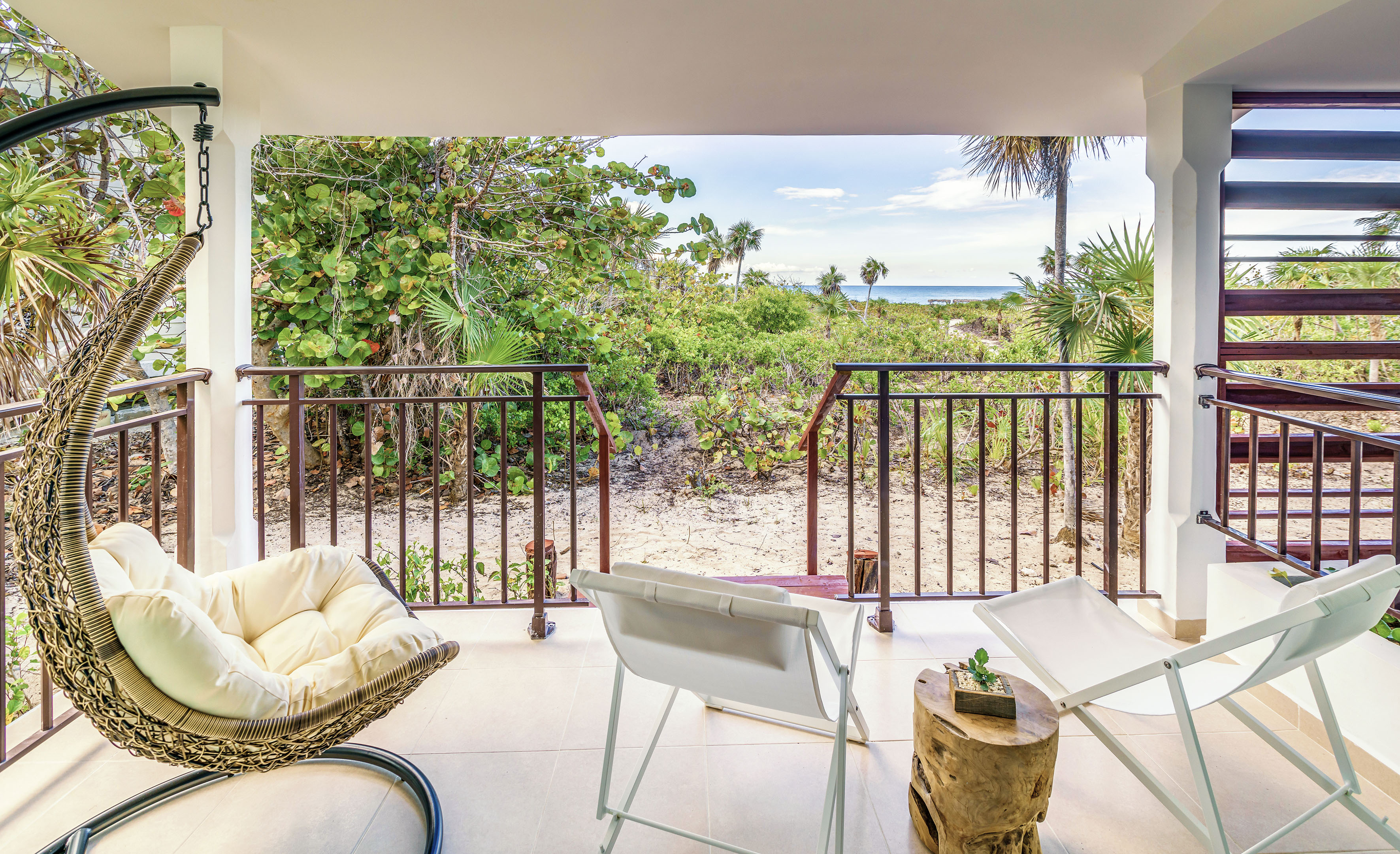 a deck with chairs and a table on it