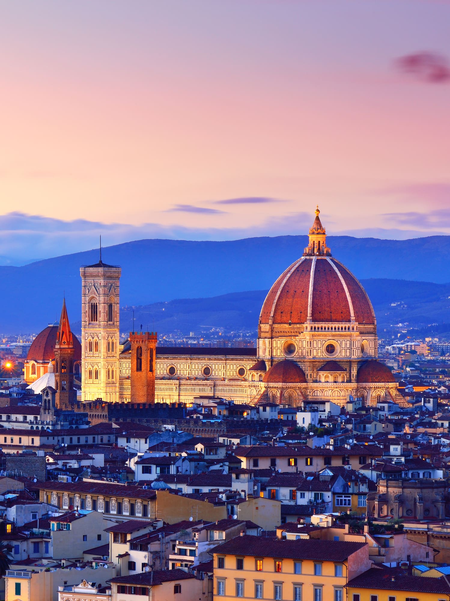 a city with a dome and a mountain in the background