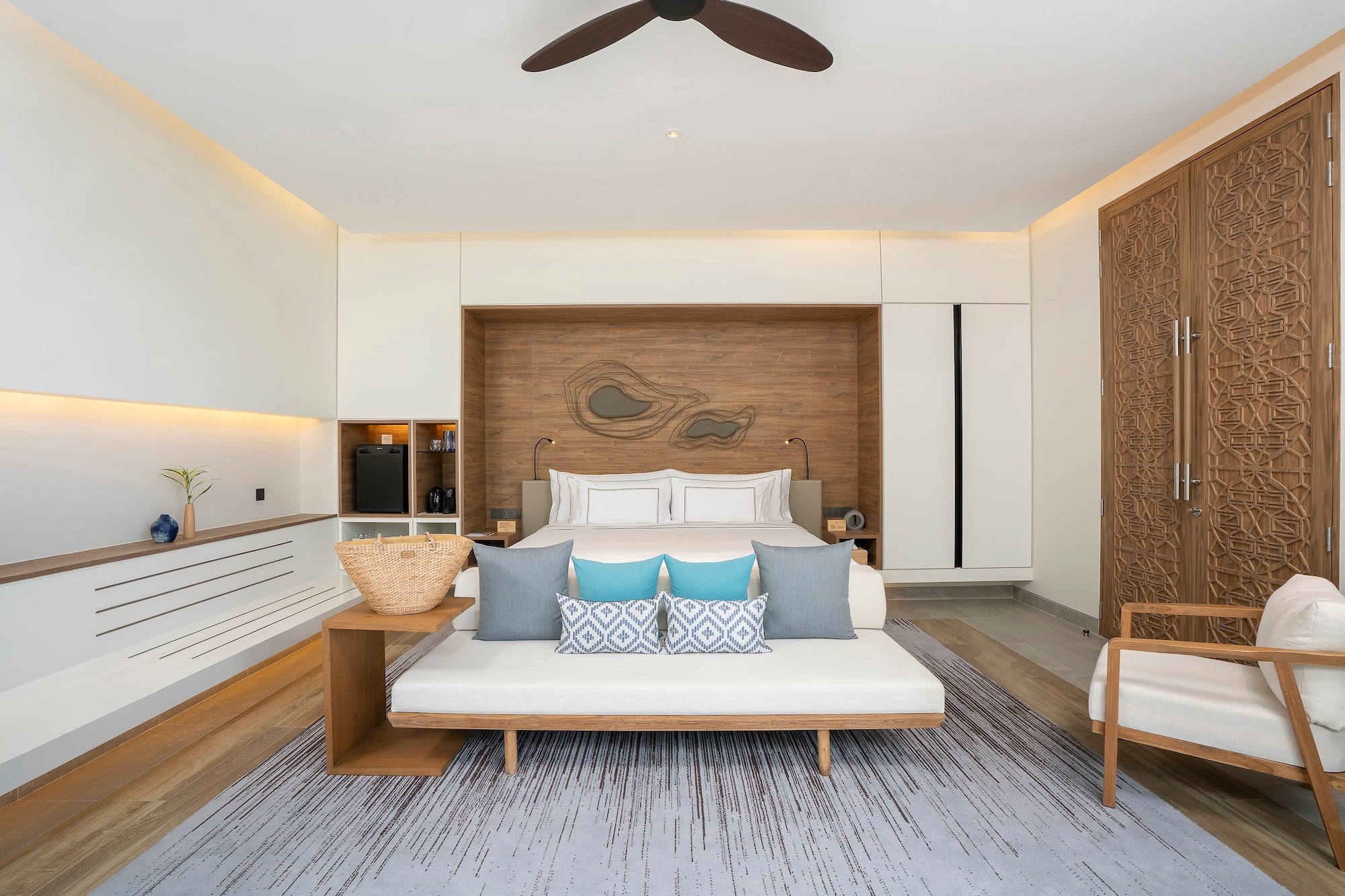 a room with a bed and a fan