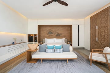 a room with a bed and a fan