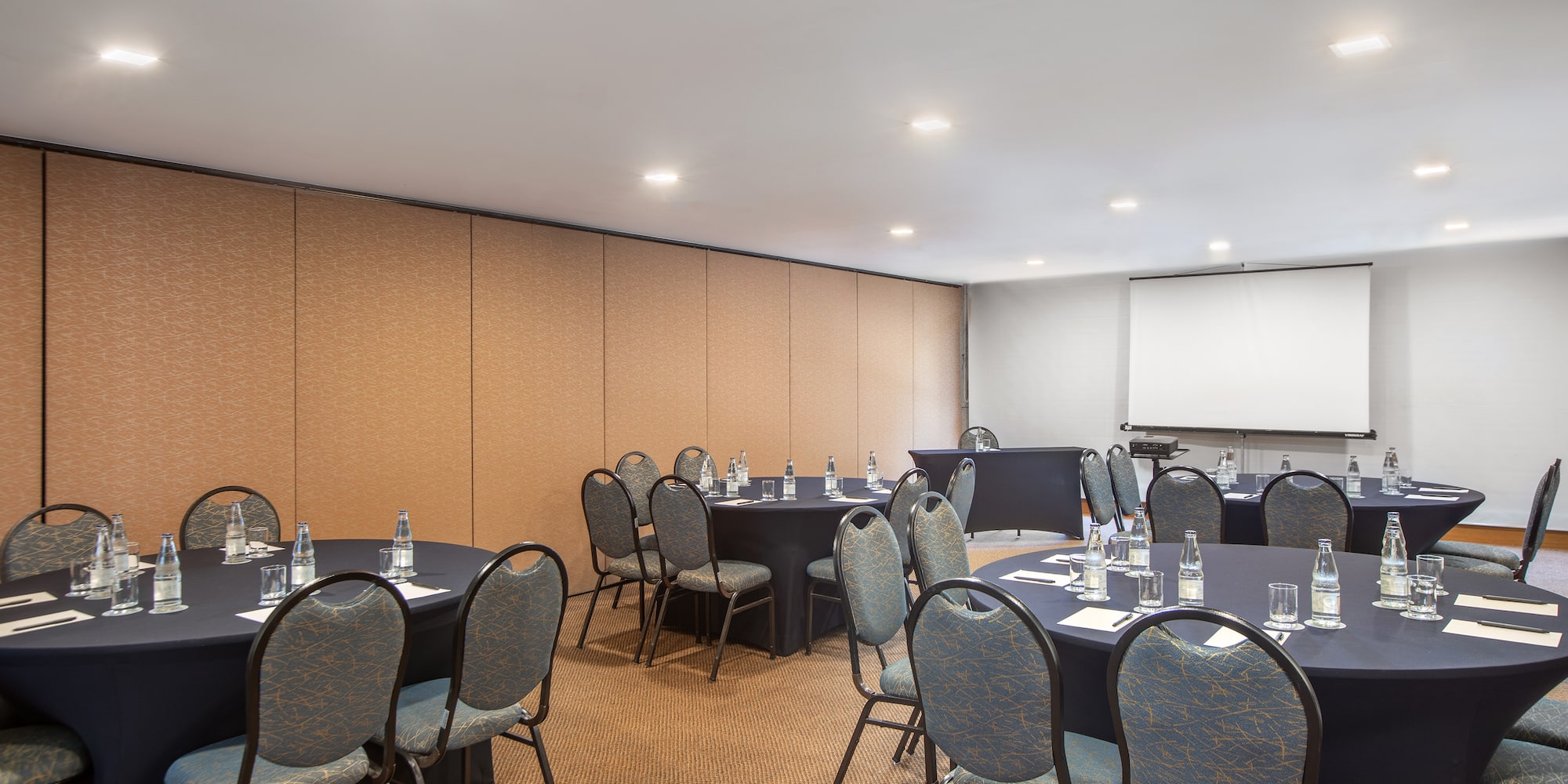 a room with round tables and chairs