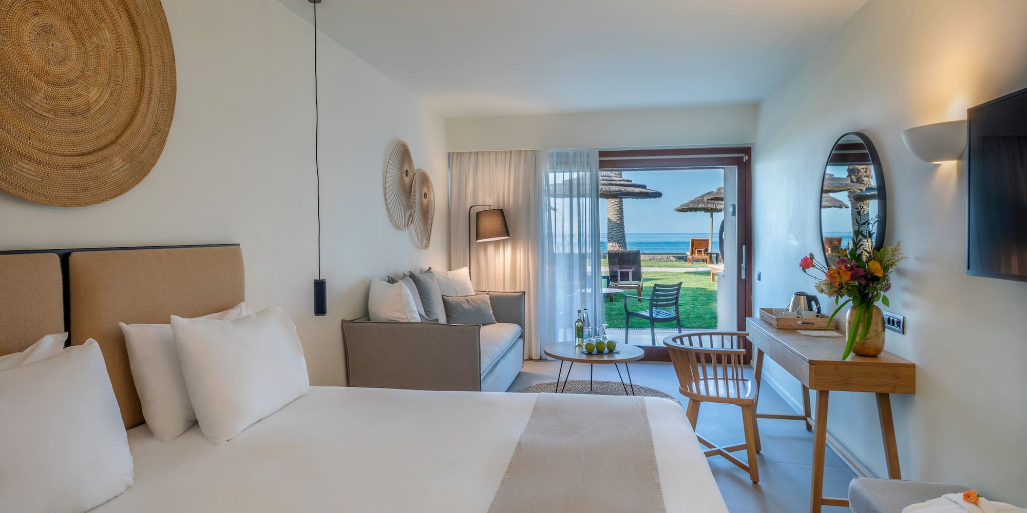 a room with a bed and a table and chairs