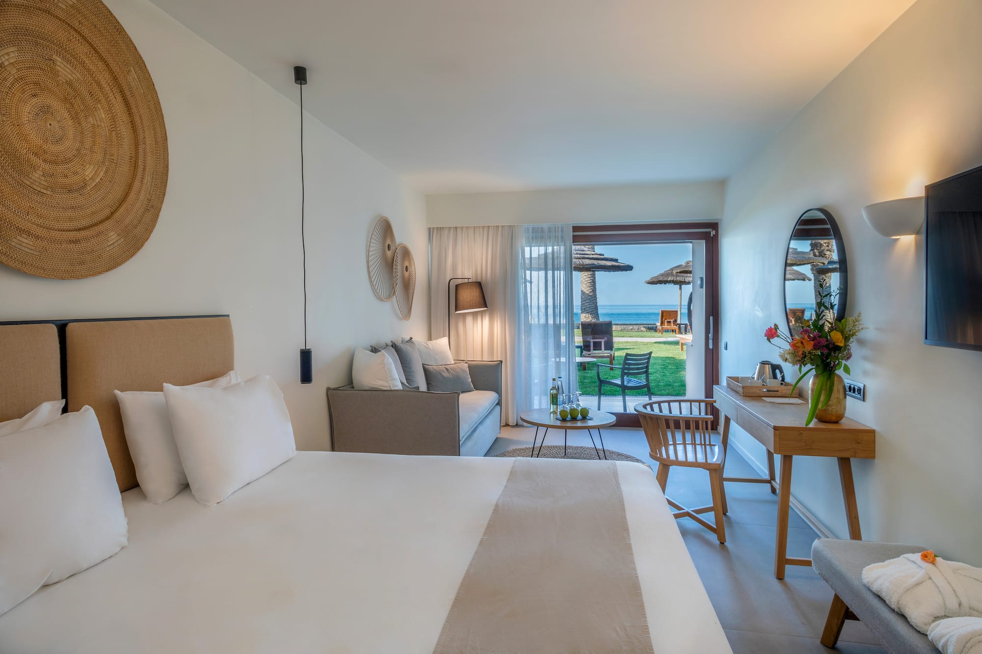 a room with a bed and a table and chairs