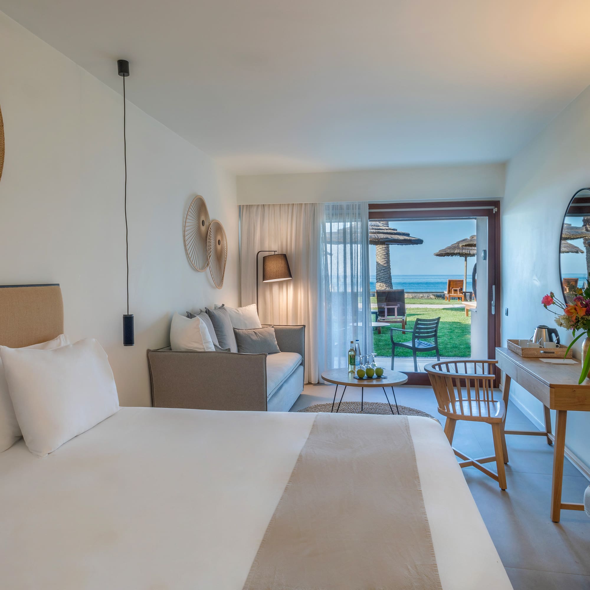 a room with a bed and a table and chairs