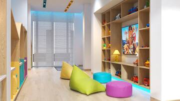 a room with a tv and colorful bean bags