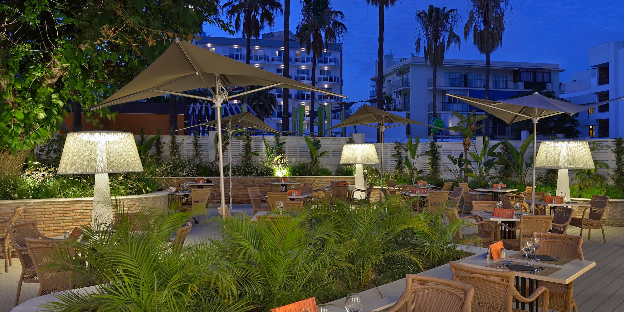a patio with tables and chairs and umbrellas