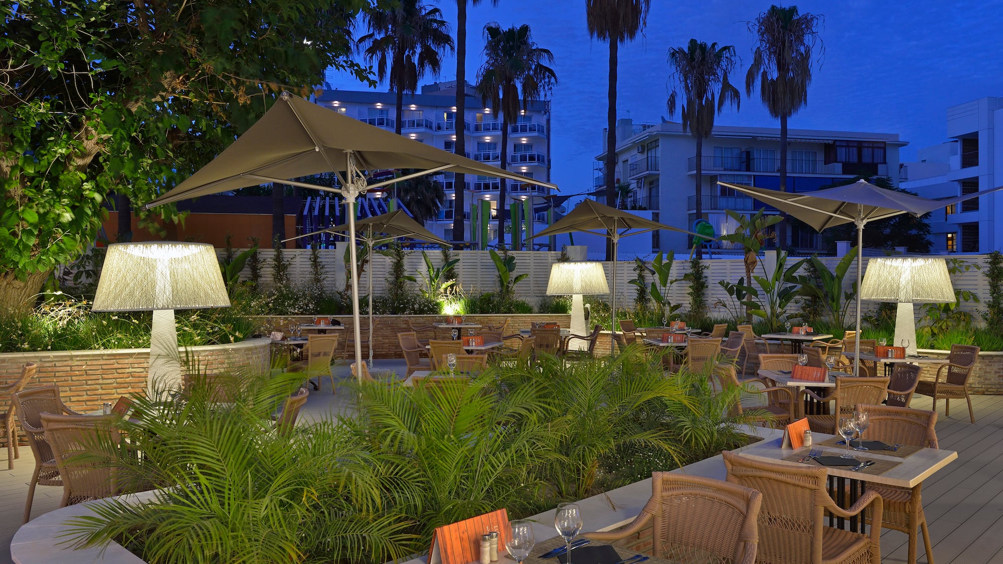 a patio with tables and chairs and umbrellas