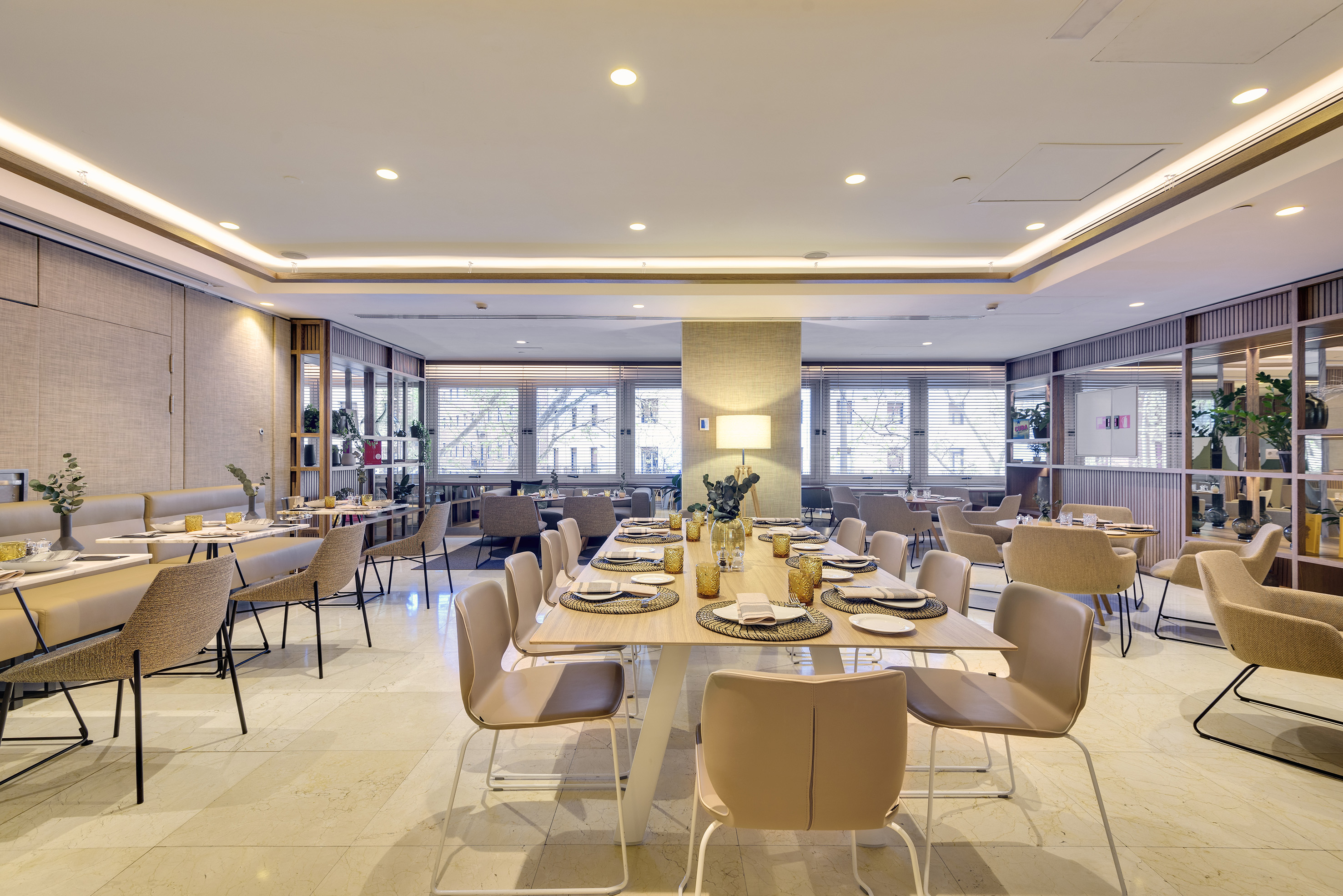 Modern hotel restaurant dining area with set tables and stylish decor.