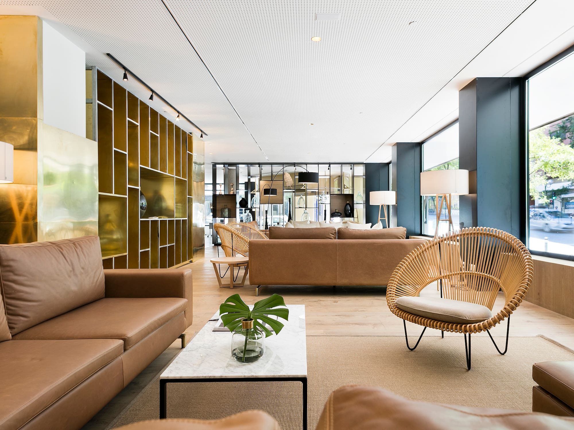 a room with brown furniture and a white table