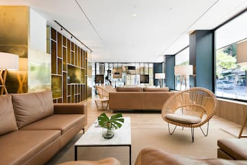 a room with brown furniture and a white table