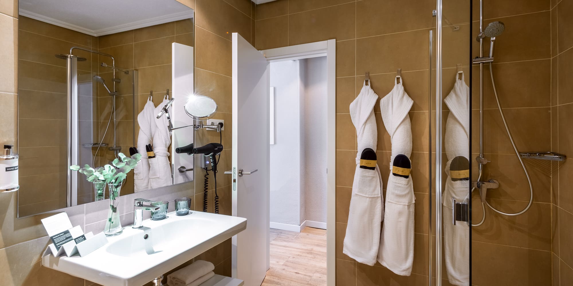 a bathroom with white towels on the wall