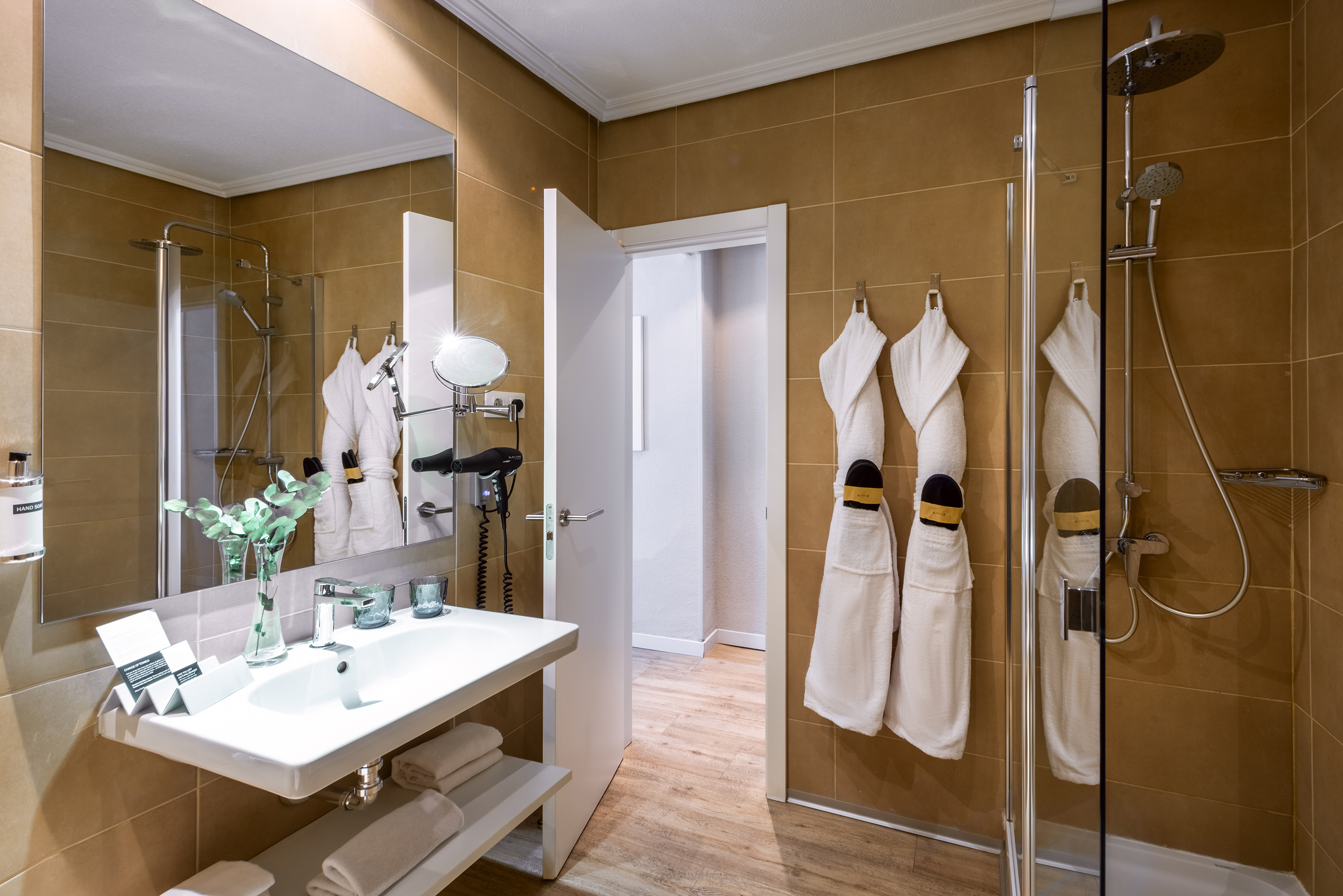 a bathroom with white towels on the wall