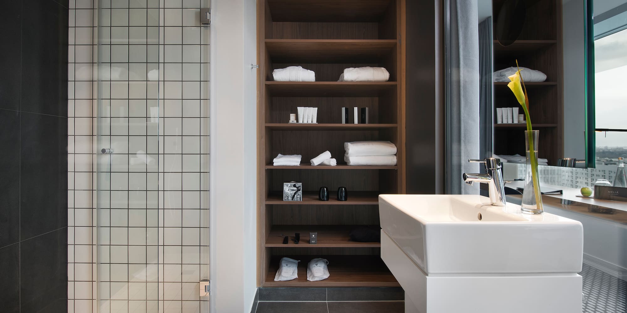 a bathroom with a sink and shelves