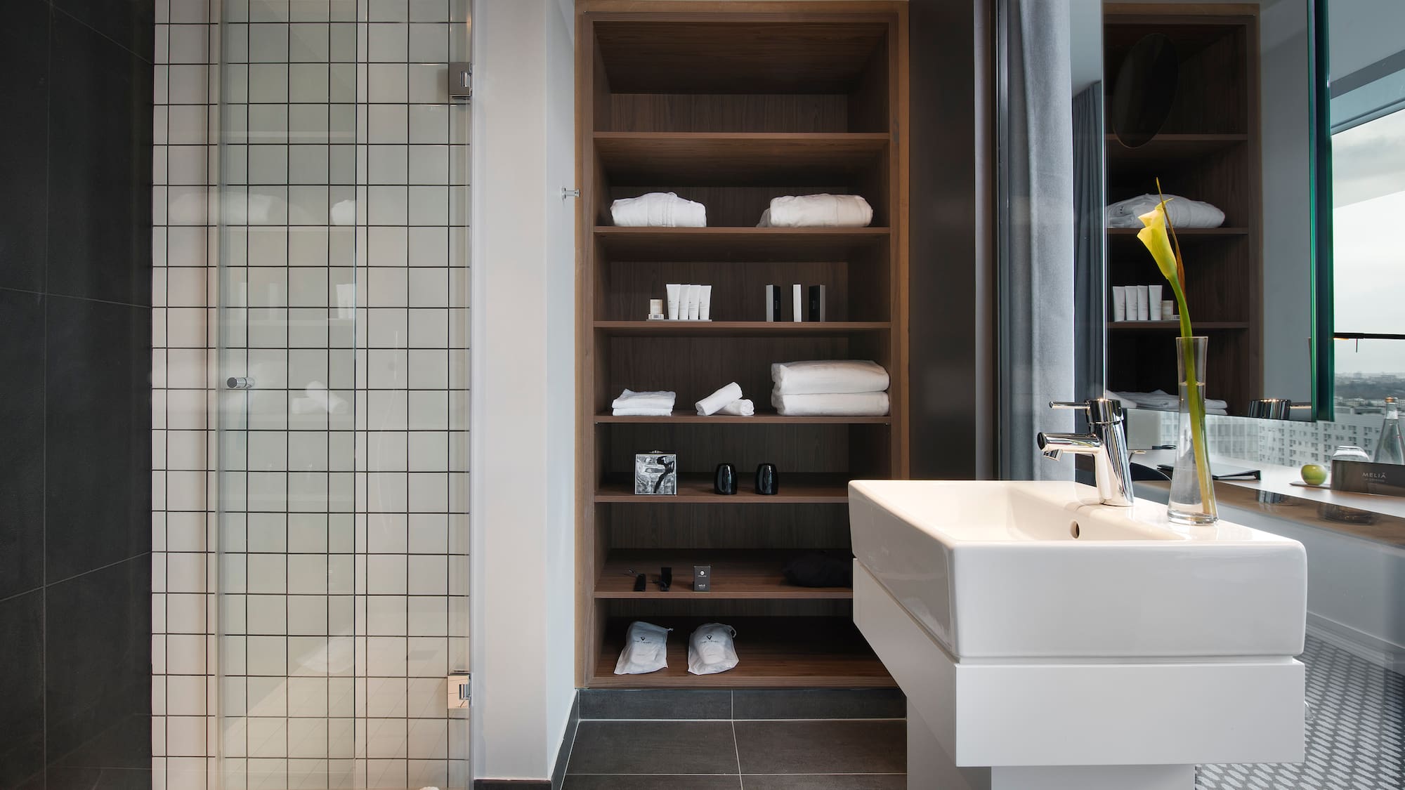 a bathroom with a sink and shelves