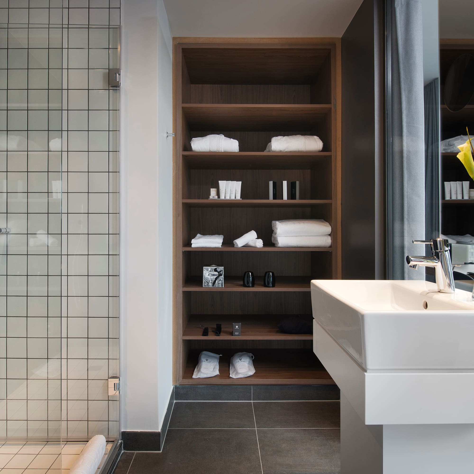 a bathroom with a sink and shelves