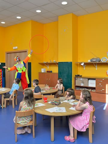a clown juggling with a hoop in a classroom