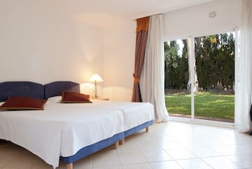 a bedroom with a bed and a glass door