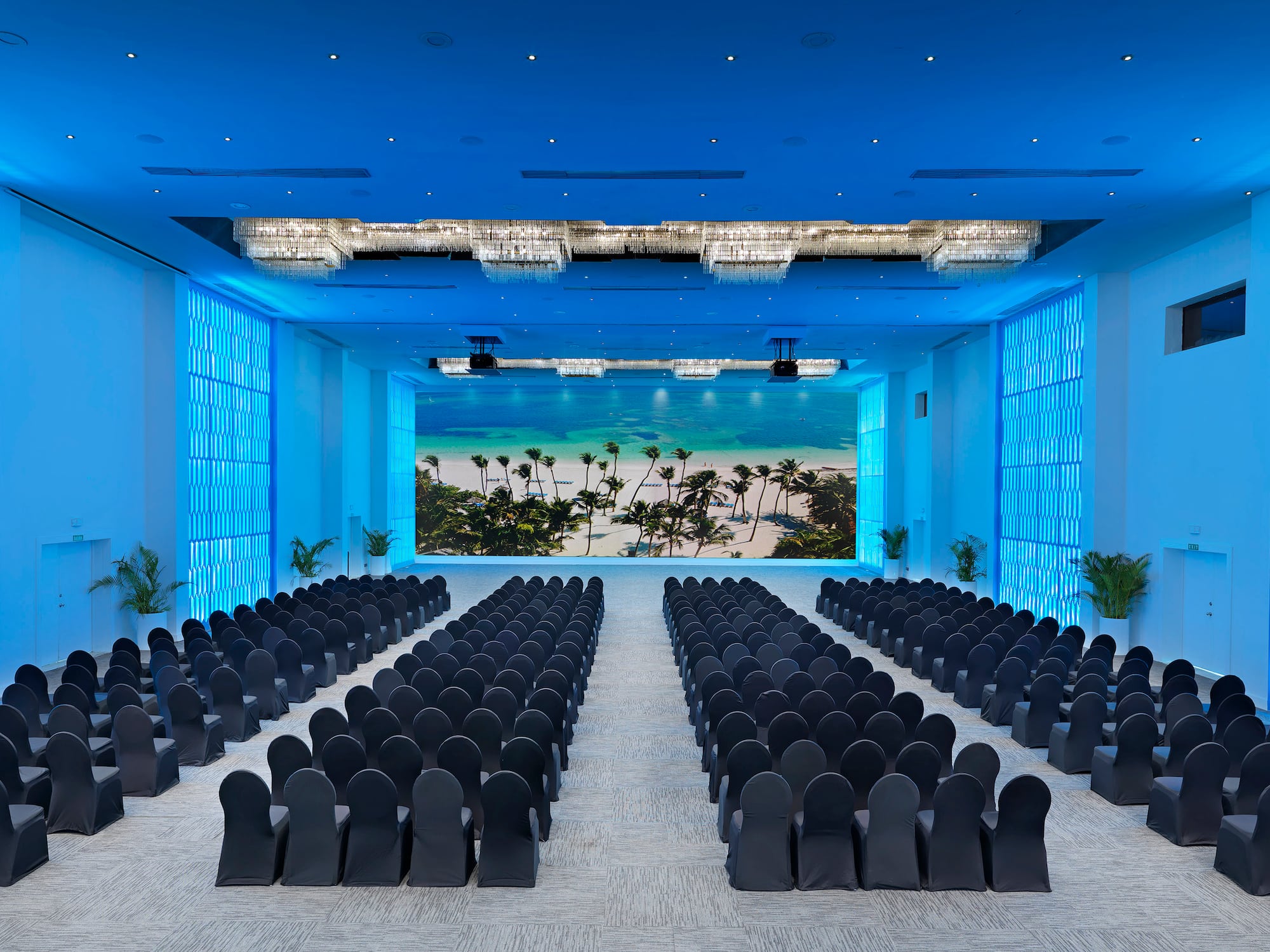a room with chairs and a view of the beach