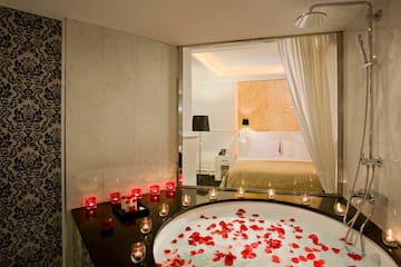 a bathtub with red candles and candles on it