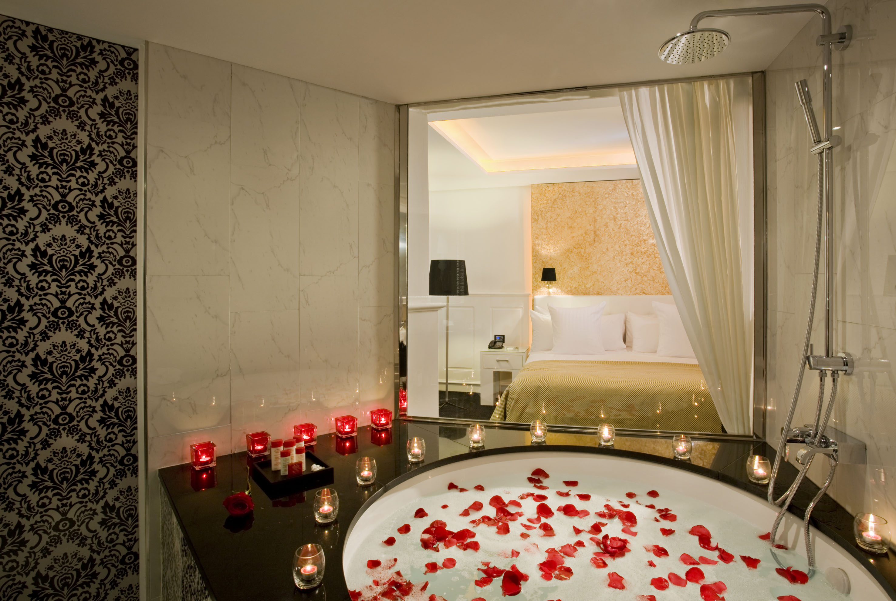 a bathtub with red candles and candles on it