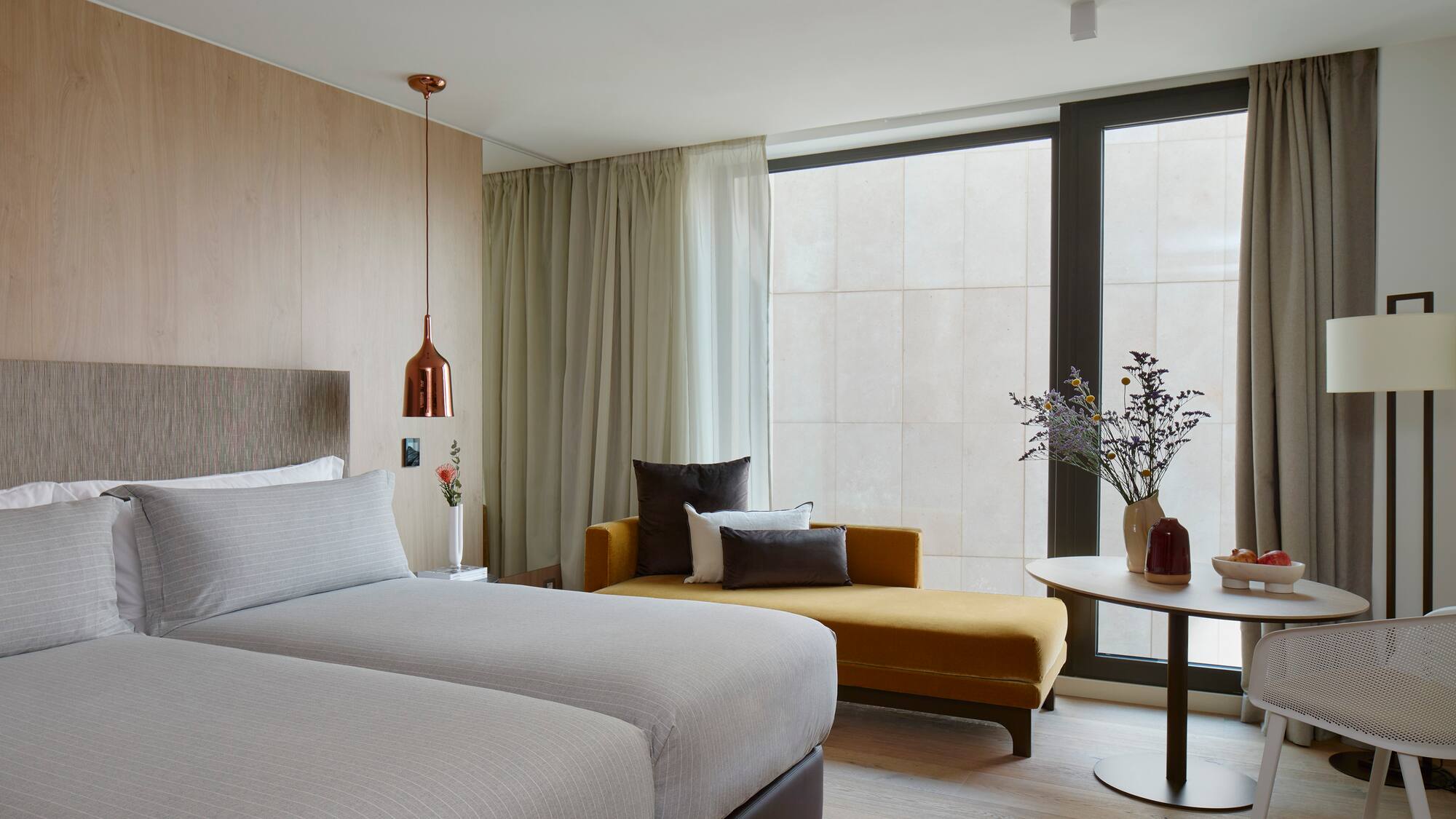 a room with two beds and a couch