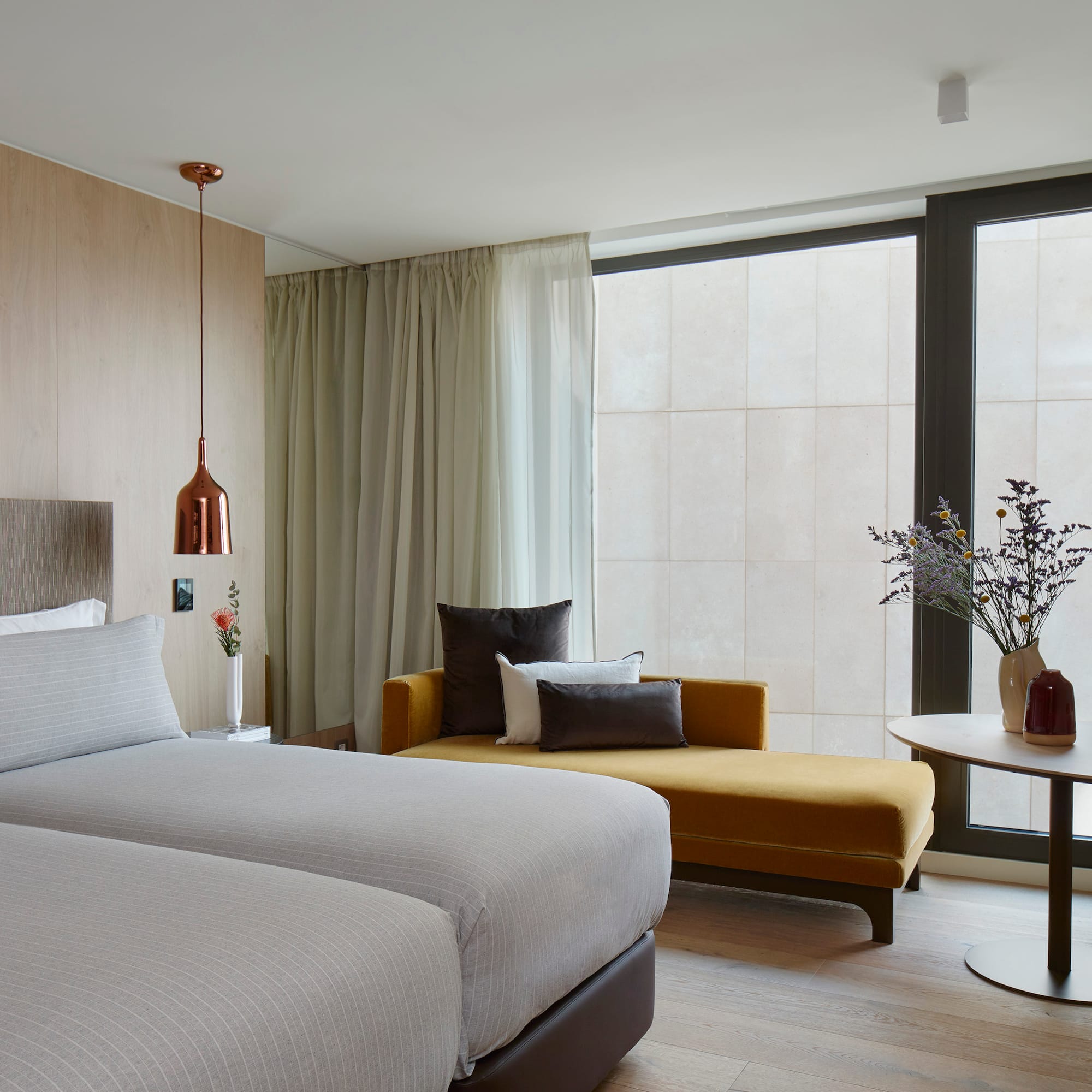 a room with two beds and a couch