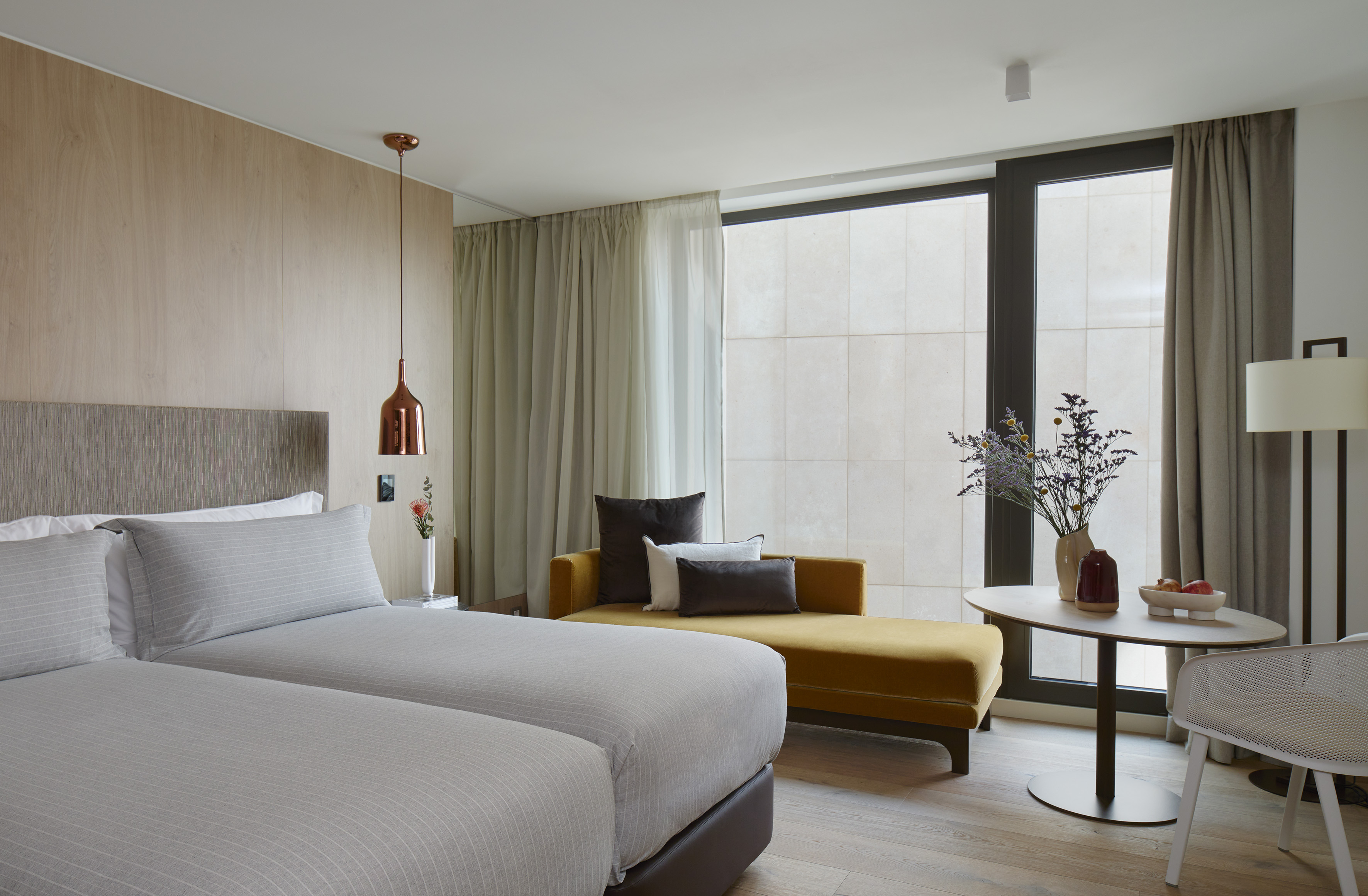 a room with two beds and a couch