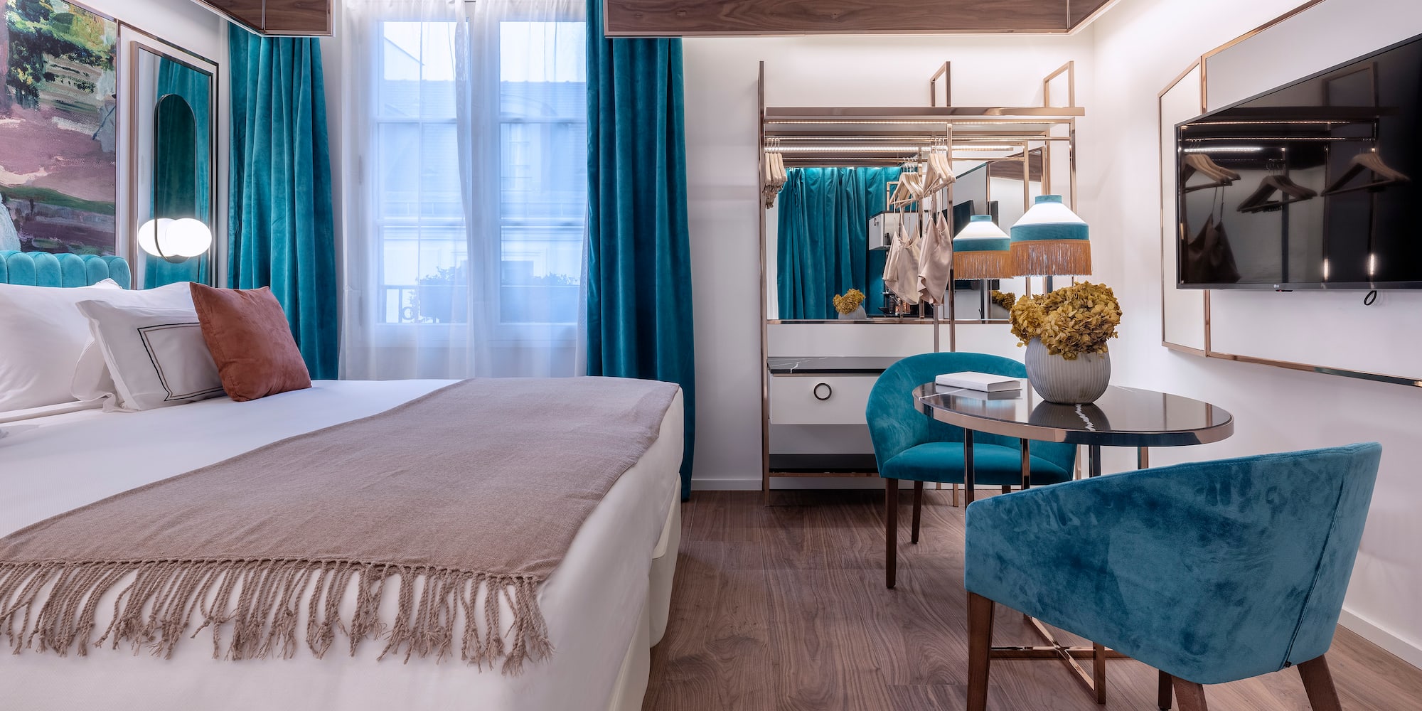 a bedroom with a bed and a table and chairs