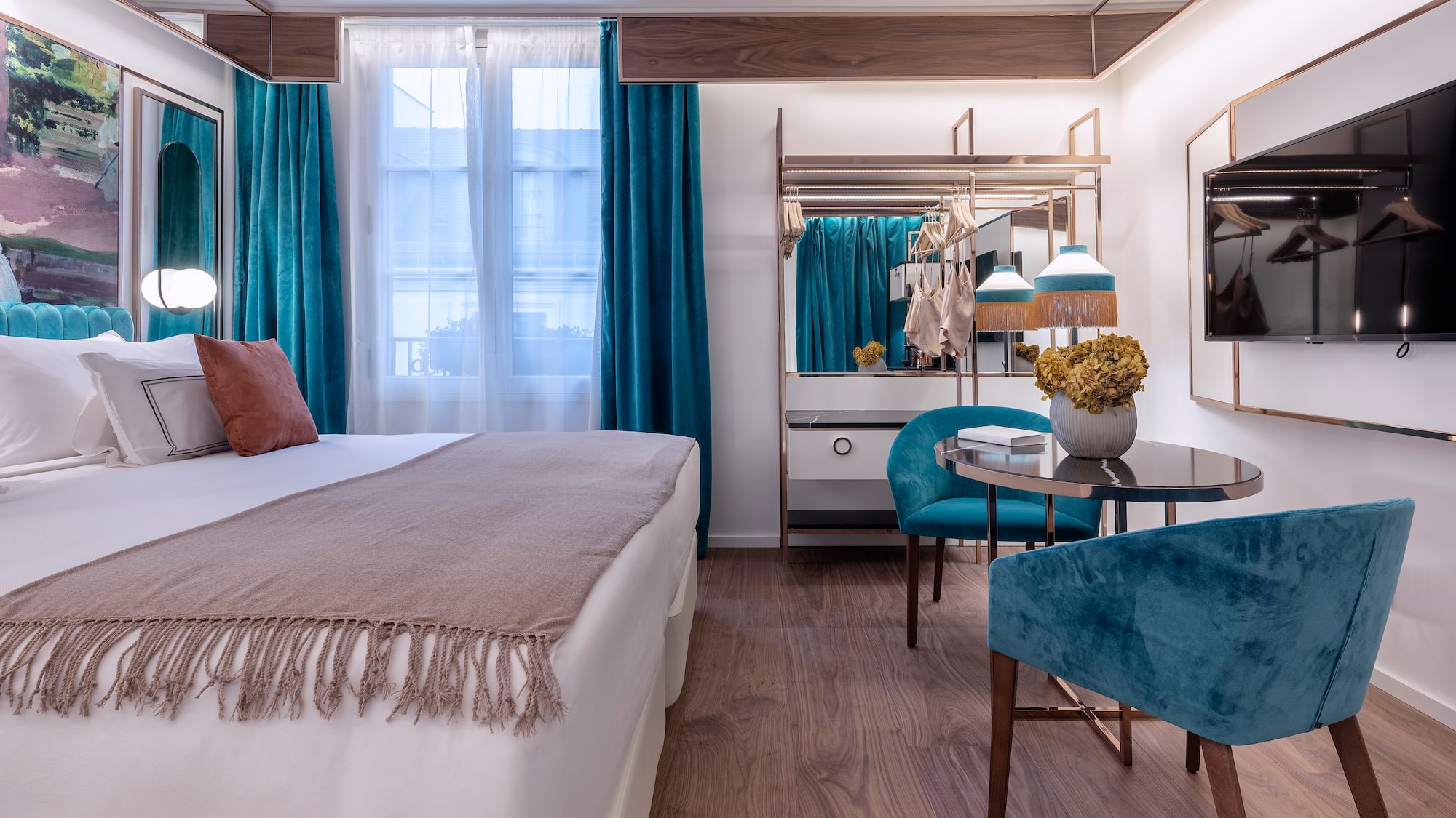 a bedroom with a bed and a table and chairs