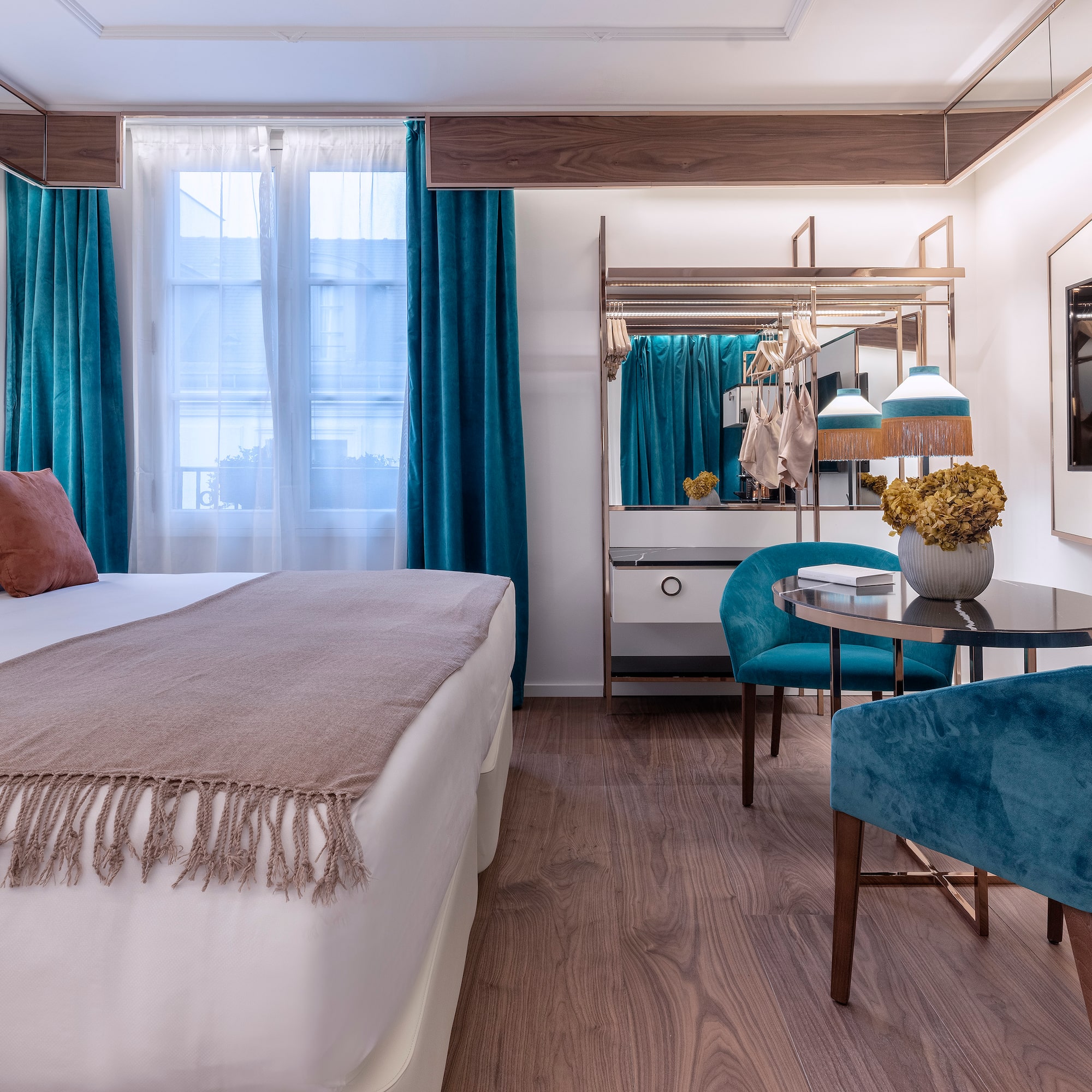 a bedroom with a bed and a table and chairs