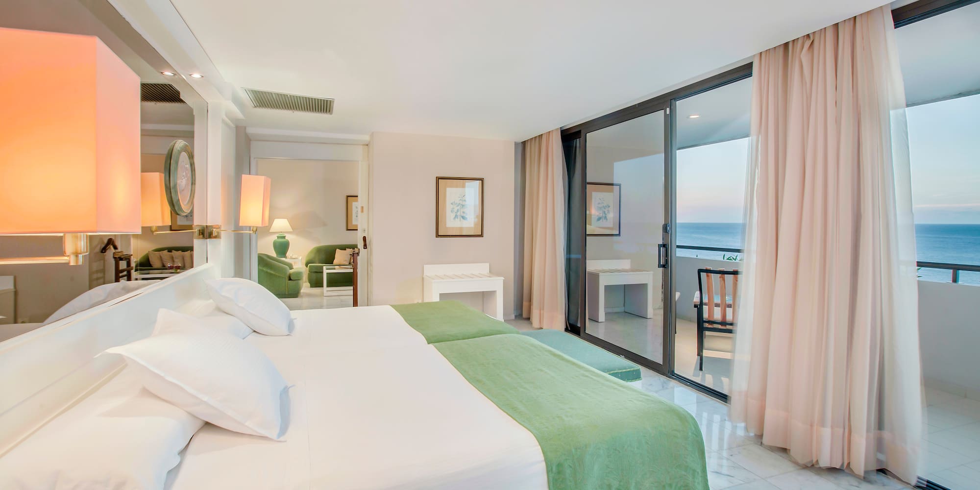 a bedroom with a glass door and a large bed