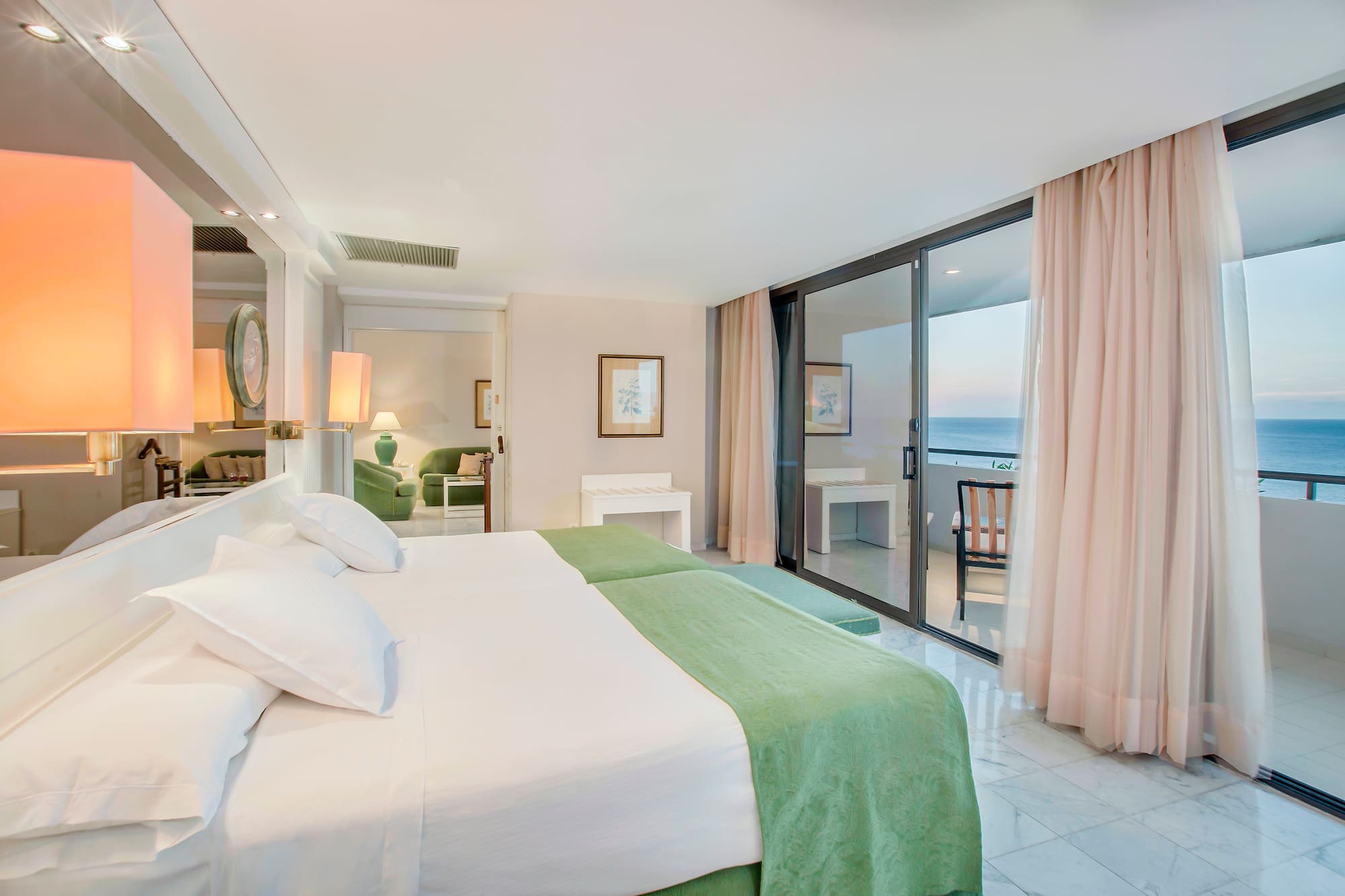 a bedroom with a glass door and a large bed