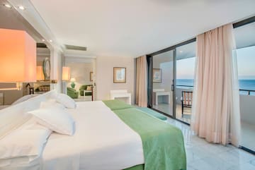 a bedroom with a glass door and a large bed