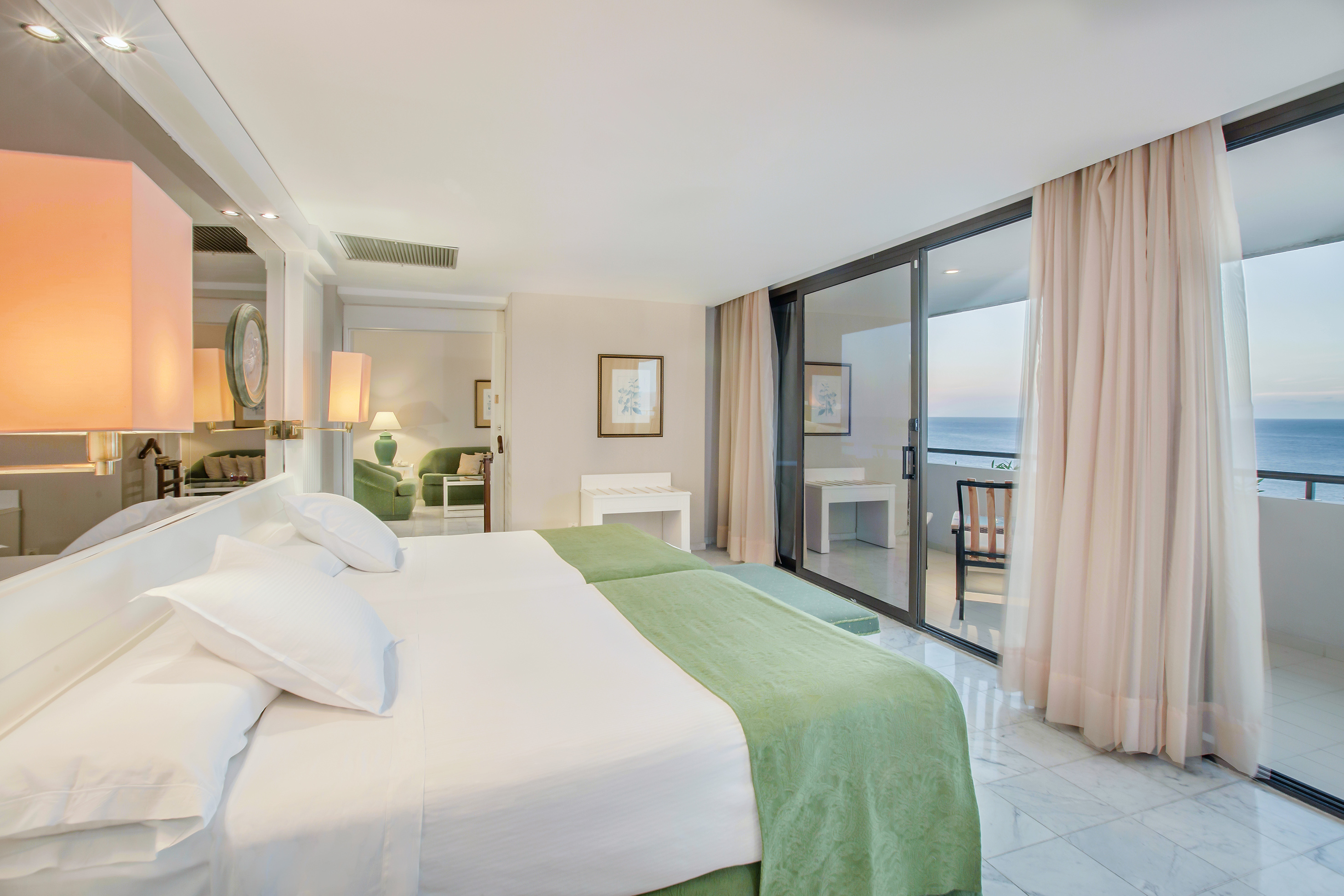 a bedroom with a glass door and a large bed