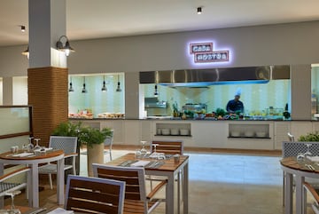 a restaurant with a chef cooking