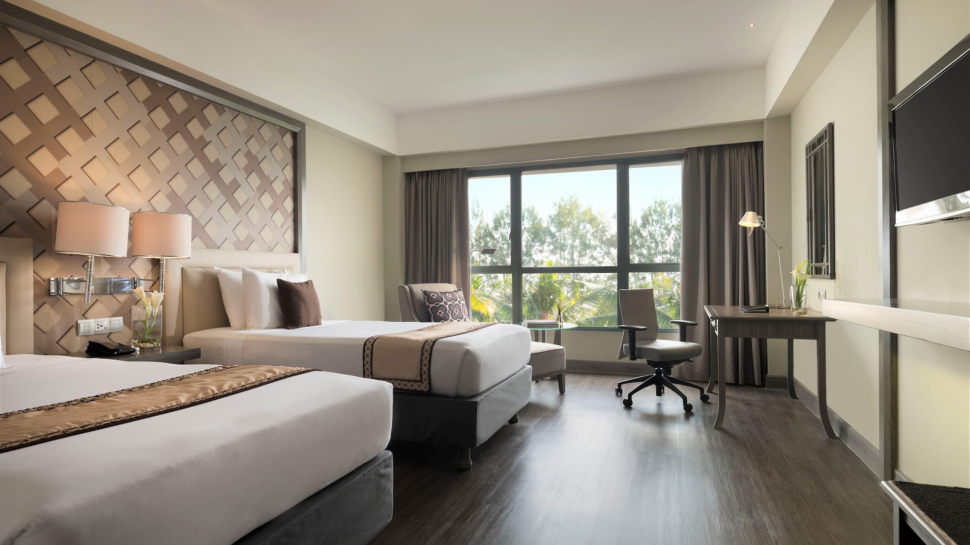 a room with two beds and a desk