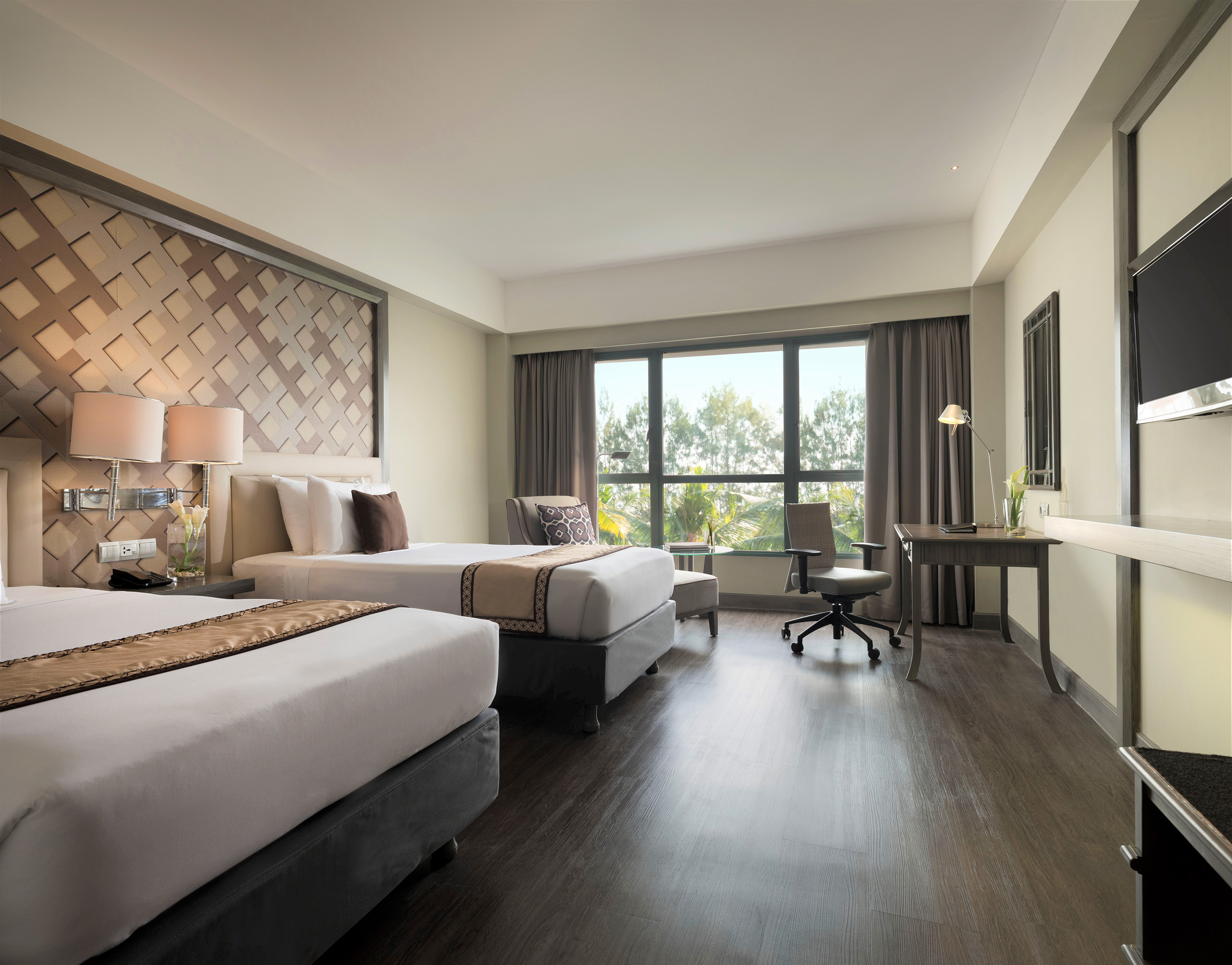 a room with two beds and a desk